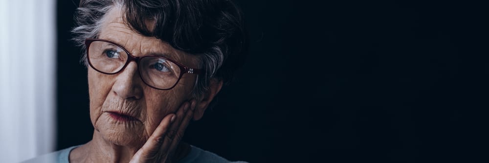 Elderly,Lonely,Woman,With,Alzheimer's,Sadly,Looking,Through,The,Window
